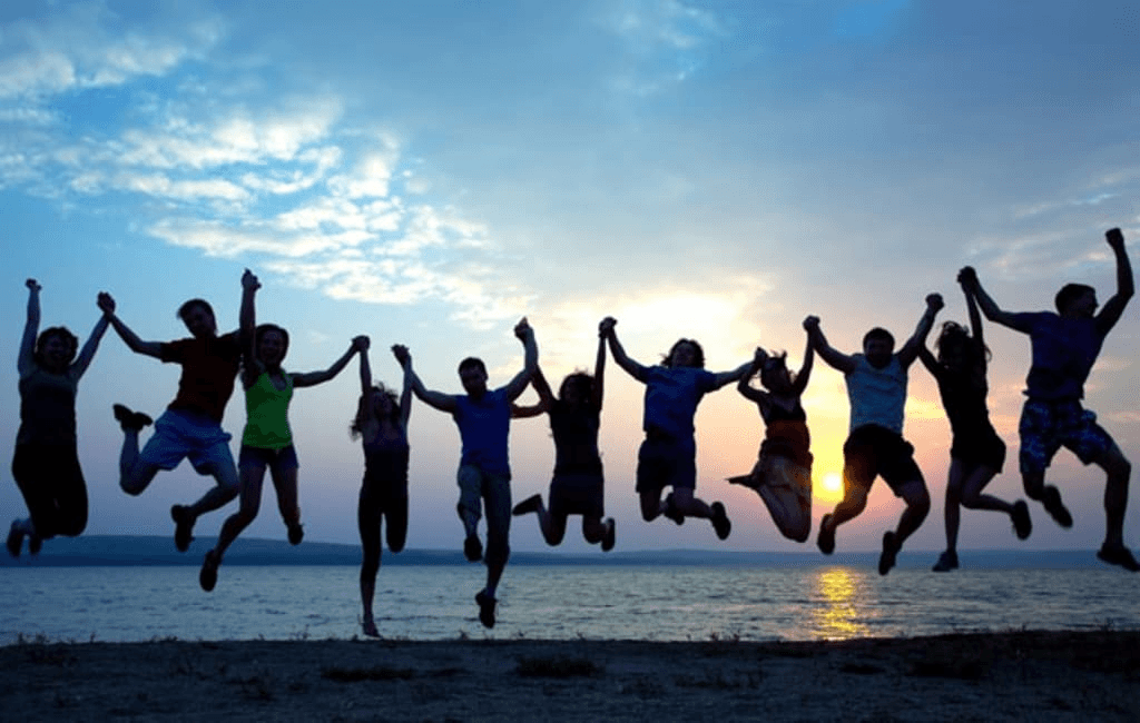 Friends jumping at sunset